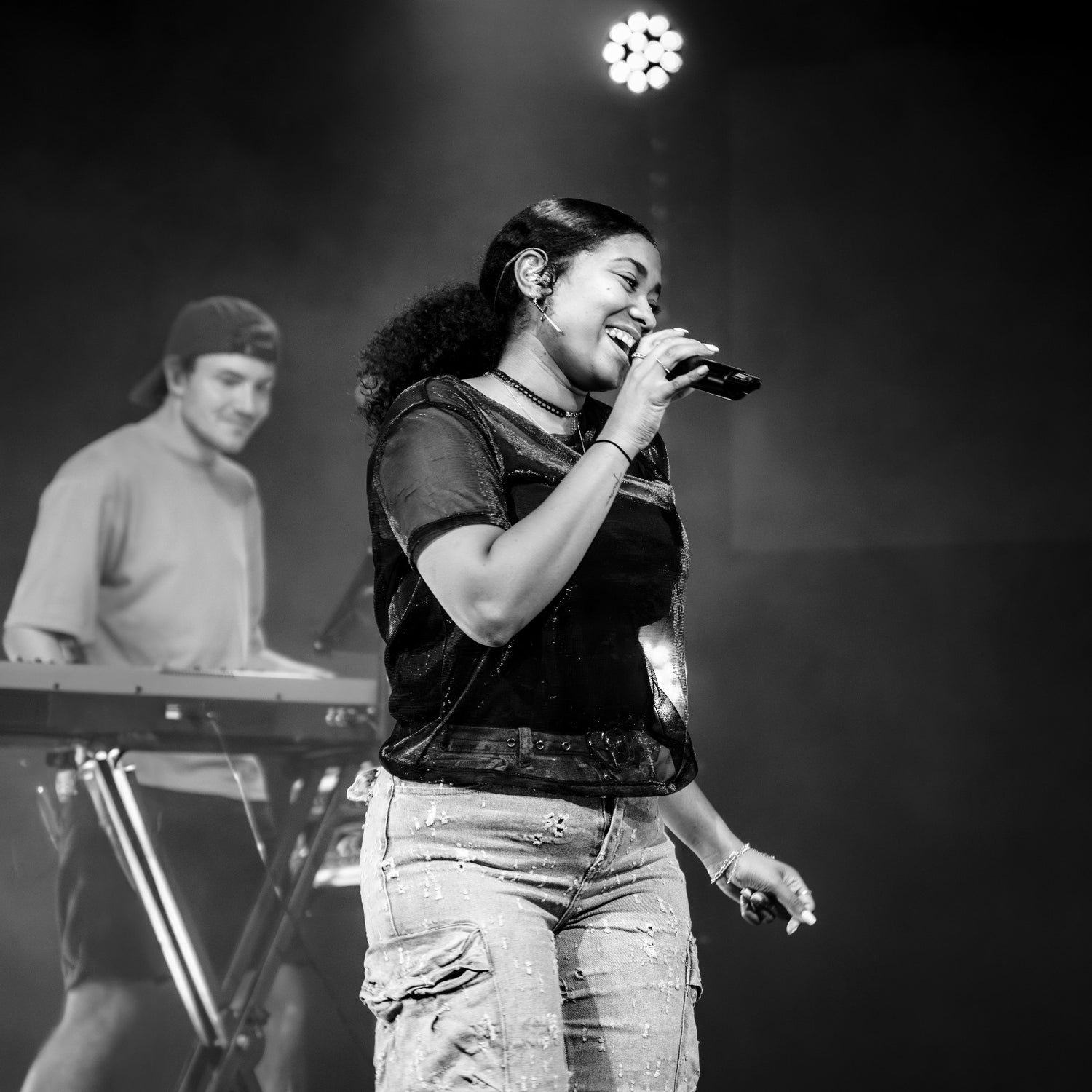 Ilaisa singing with Beam worshipband keyboardist during live worship set, black-and-white stage photo